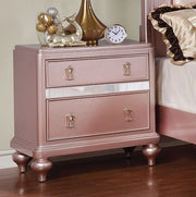 FoA West Ariston rose gold nightstand with a sleek modern design and drawer storage, placed beside a bed.